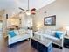 Comfortable living room showcasing a fireplace, an entertainment center, and views of the kitchen and dining area at 700 Wyckliffe Pl, Winter Springs, FL 32708