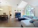 Open-concept living room with hardwood floors, a large window, and a comfortable sectional sofa at 700 Wyckliffe Pl, Winter Springs, FL 32708