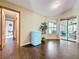 Cozy living room featuring a retro mini fridge and leads to the sunroom at 700 Wyckliffe Pl, Winter Springs, FL 32708