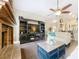 Cozy living room featuring a fireplace, entertainment center, and open access to the kitchen area at 700 Wyckliffe Pl, Winter Springs, FL 32708
