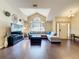 Bright living room featuring hardwood floors, high ceilings, and comfortable seating at 700 Wyckliffe Pl, Winter Springs, FL 32708