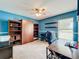 Bright office featuring a ceiling fan, large window, built in shelving and a wooden Murphy bed at 700 Wyckliffe Pl, Winter Springs, FL 32708