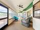 Enclosed sunroom with multiple windows, two ceiling fans, and wicker furniture at 700 Wyckliffe Pl, Winter Springs, FL 32708