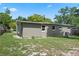The exterior of the home features a light green facade, an AC unit, and several windows at 709 Suzette Dr, Ocoee, FL 34761