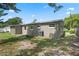 The backyard of the home with a light green facade and an AC unit at 709 Suzette Dr, Ocoee, FL 34761
