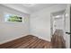 Bedroom featuring wood-look flooring, a window, and a double-door closet at 709 Suzette Dr, Ocoee, FL 34761