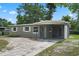Charming single story home featuring neutral paint, white trim, and a covered carport at 709 Suzette Dr, Ocoee, FL 34761