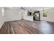 Bright living room showcasing wood floors, white trim, and an open floor plan to the kitchen at 709 Suzette Dr, Ocoee, FL 34761