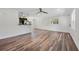 Bright living room showcasing wood floors, white trim, and an open floor plan to the kitchen at 709 Suzette Dr, Ocoee, FL 34761