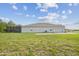 The backyard has a screened-in patio and green space at 730 Rominger Loop, Apopka, FL 32712
