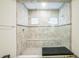 Bright bathroom shower featuring neutral tile, glass surround, and built in bench seating at 730 Rominger Loop, Apopka, FL 32712