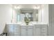 Elegant bathroom featuring a dual sink vanity with bright white cabinetry and stone countertop at 730 Rominger Loop, Apopka, FL 32712