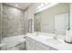 Bright bathroom with dual sinks, bright white cabinetry, and shower-tub combination at 730 Rominger Loop, Apopka, FL 32712