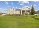 Charming gray home with green lawn, lovely plants, and welcoming front porch at 730 Rominger Loop, Apopka, FL 32712