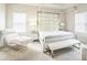 Bright main bedroom with a statement four-poster bed, plush chair and neutral colors at 730 Rominger Loop, Apopka, FL 32712