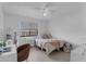Bright bedroom featuring a ceiling fan, a window and tile floors, creating a cozy and inviting space at 7344 Swallow Run # 7344, Winter Park, FL 32792