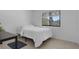 This bedroom features a bed, tile floors and a window overlooking a green outdoor view at 7344 Swallow Run # 7344, Winter Park, FL 32792
