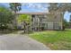 Two-story townhouse with exterior stairs and an asphalt driveway at 7344 Swallow Run # 7344, Winter Park, FL 32792