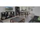 A living room featuring a black sofa, kitchen, and kitchen counter at 7344 Swallow Run # 7344, Winter Park, FL 32792