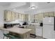 A kitchen featuring a microwave, stove, dishwasher, and refrigerator at 7344 Swallow Run # 7344, Winter Park, FL 32792