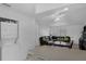 A living room featuring a black sofa, washer, and dryer at 7344 Swallow Run # 7344, Winter Park, FL 32792