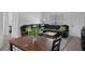 A living room featuring a black leather sofa and a wooden table at 7344 Swallow Run # 7344, Winter Park, FL 32792