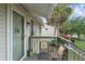 Welcoming porch with chairs, a table, and views of a palm tree adding charm to the entrance at 7344 Swallow Run # 7344, Winter Park, FL 32792