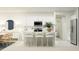 Modern white kitchen with stainless steel appliances, central island with seating, and adjacent dining area at 7473 Capstone Dr, Groveland, FL 34736