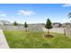 Spacious, green backyard featuring a play structure, lush grass and a white fence at 7603 Taormina Way, Clermont, FL 34714
