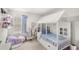 Cozy bedroom design with white house frame bed, pastel decor, and ample lighting at 7603 Taormina Way, Clermont, FL 34714