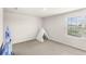 Empty bedroom showcasing a window with neighborhood views and room for versatile use at 7603 Taormina Way, Clermont, FL 34714