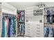 Spacious walk-in closet with custom shelving, hanging rods, drawers, and ample storage space at 7603 Taormina Way, Clermont, FL 34714