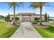 Community clubhouse entrance with palm trees and manicured landscaping welcoming residents and guests at 7603 Taormina Way, Clermont, FL 34714