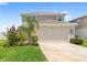 Charming two-story home with a two-car garage and a well-maintained front yard at 7603 Taormina Way, Clermont, FL 34714