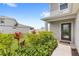 Landscaped front yard, with colorful plantings and a walkway to the front door at 7603 Taormina Way, Clermont, FL 34714