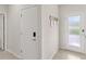 Bright hallway with a front door and a closet door at 7603 Taormina Way, Clermont, FL 34714