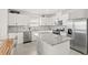 Modern kitchen with stainless steel appliances, granite countertops, and ample cabinet space at 7603 Taormina Way, Clermont, FL 34714