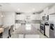 Bright and airy kitchen with granite countertops, stainless steel appliances, and a dining table at 7603 Taormina Way, Clermont, FL 34714