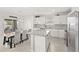 Well-lit kitchen and dining area with granite countertops, stainless steel appliances, and ample seating at 7603 Taormina Way, Clermont, FL 34714