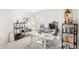 Home office with a modern desk, shelves, ergonomic chair, and natural light from the window at 7603 Taormina Way, Clermont, FL 34714