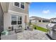 Outdoor patio with gray furniture, umbrella, and barbecue grill at 7603 Taormina Way, Clermont, FL 34714