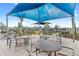 Outdoor picnic area with tables, chairs, and BBQ grills under a shaded structure at 7603 Taormina Way, Clermont, FL 34714