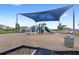 Community playground shaded by a large canopy, providing a fun and safe environment for children at 7603 Taormina Way, Clermont, FL 34714