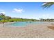 Expansive community pool with zero-entry, splash features and plenty of lounge chairs for relaxing at 7603 Taormina Way, Clermont, FL 34714