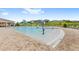 Large community pool with beach entry, water features, and lounge chairs at 7603 Taormina Way, Clermont, FL 34714