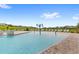 A zero-entry community pool features shallow water areas and playful water features for Gathering enjoyment at 7603 Taormina Way, Clermont, FL 34714