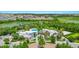 Gorgeous aerial view of the community's amenities, showcasing the pool, spa, and well-manicured landscaping at 812 Benoi Dr, Davenport, FL 33896