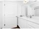 Bathroom featuring a white vanity with countertop, sink, a mirror, and a door at 812 Benoi Dr, Davenport, FL 33896