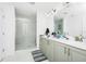 Modern bathroom with a glass-enclosed shower and double vanity at 812 Benoi Dr, Davenport, FL 33896