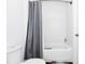 Clean bathroom featuring a bathtub, shower with curtain, toilet, and white tiled walls at 812 Benoi Dr, Davenport, FL 33896